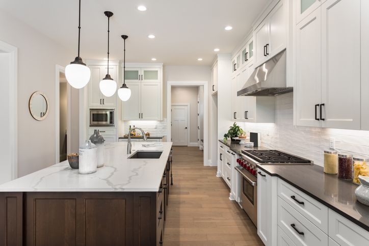 Custom quartz countertops with an integrated quartz backsplash in a contemporary kitchen.