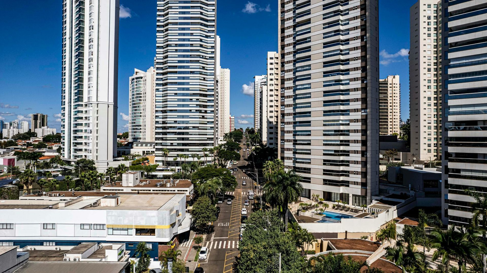 An aerial view of a city with lots of tall buildings and trees.
