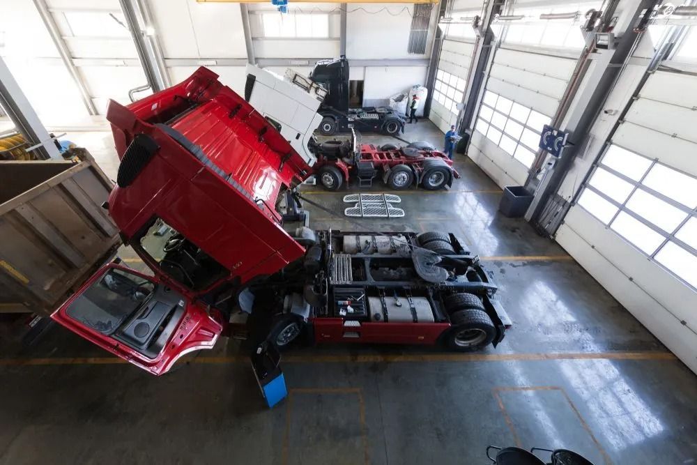 High-angle Shot of a Red Truck With Its Cab Tilted Forward for Maintenance — B & W Commercials In Wauchope, NSW