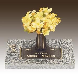 a grave marker for sherri mayson with flowers in a vase