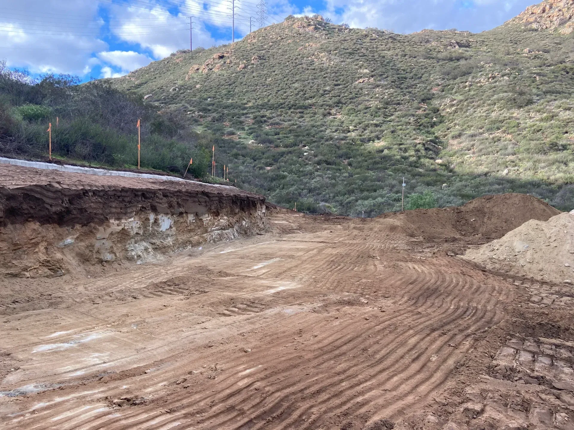 Dirt clearing for construction with a mountain backdrop.