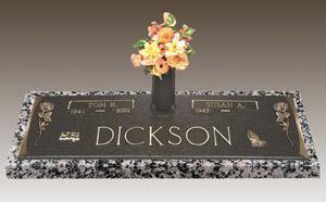 a gravestone for dickson with a vase of flowers on top of it .