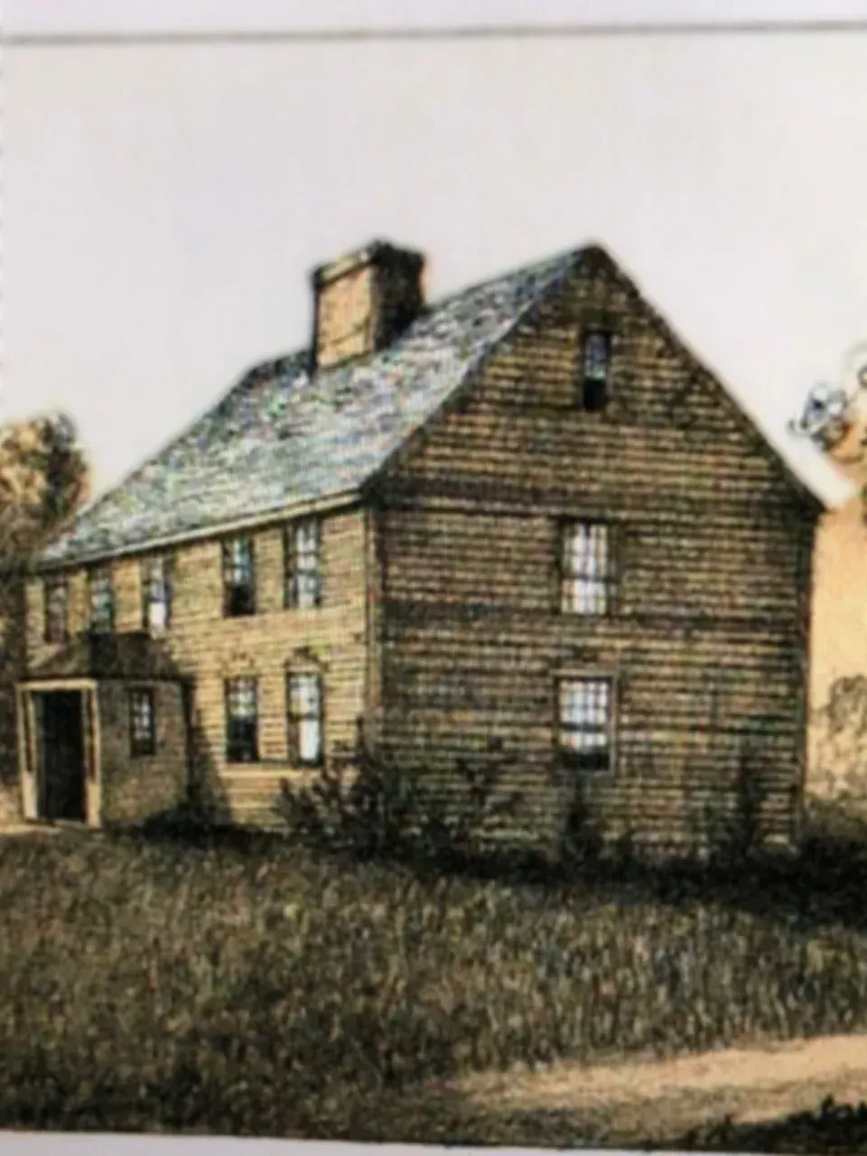Two-story wooden house with a gabled roof, chimney, and porch, set in a field.
