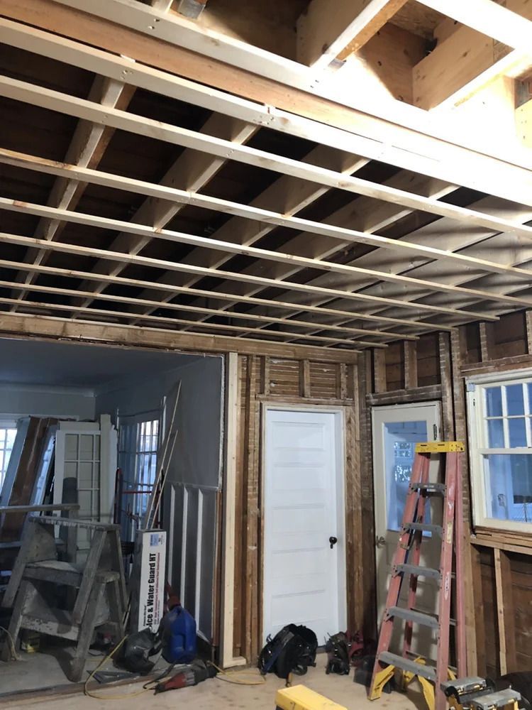 Interior ceiling and wall framing during home renovation.