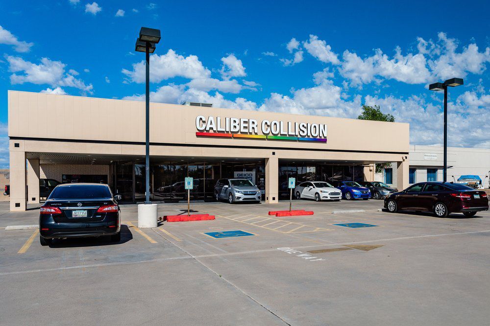 A car dealership with cars parked in front of it