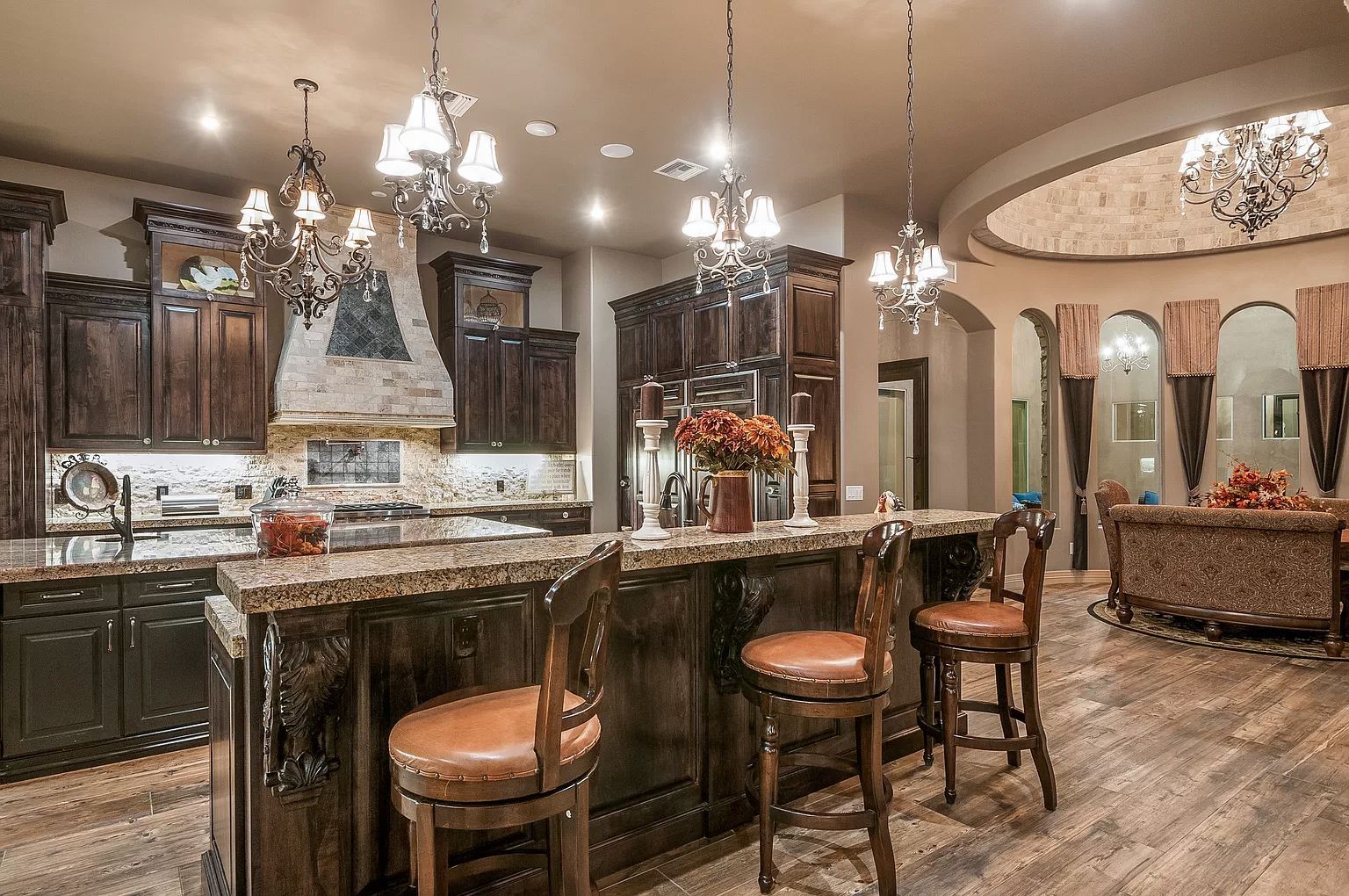 A large kitchen with a large island and chairs