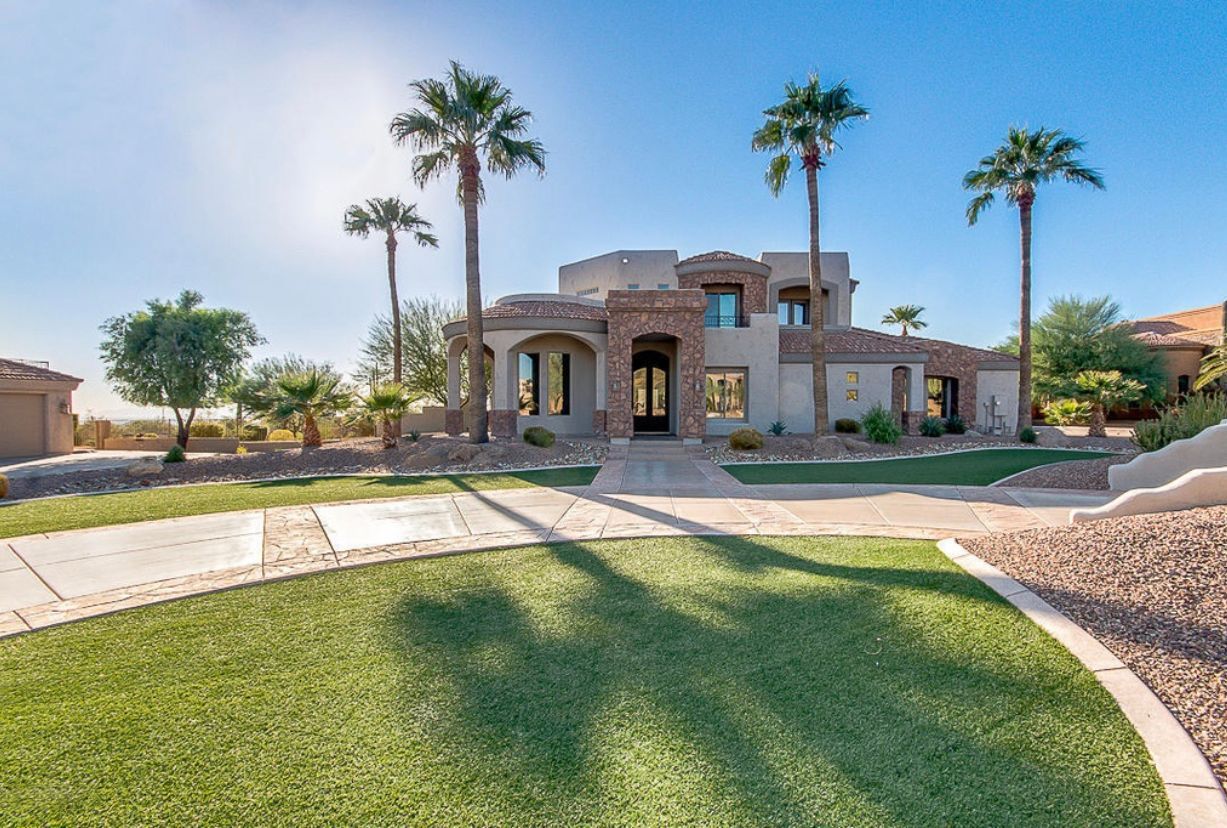 A large house with palm trees in front of it
