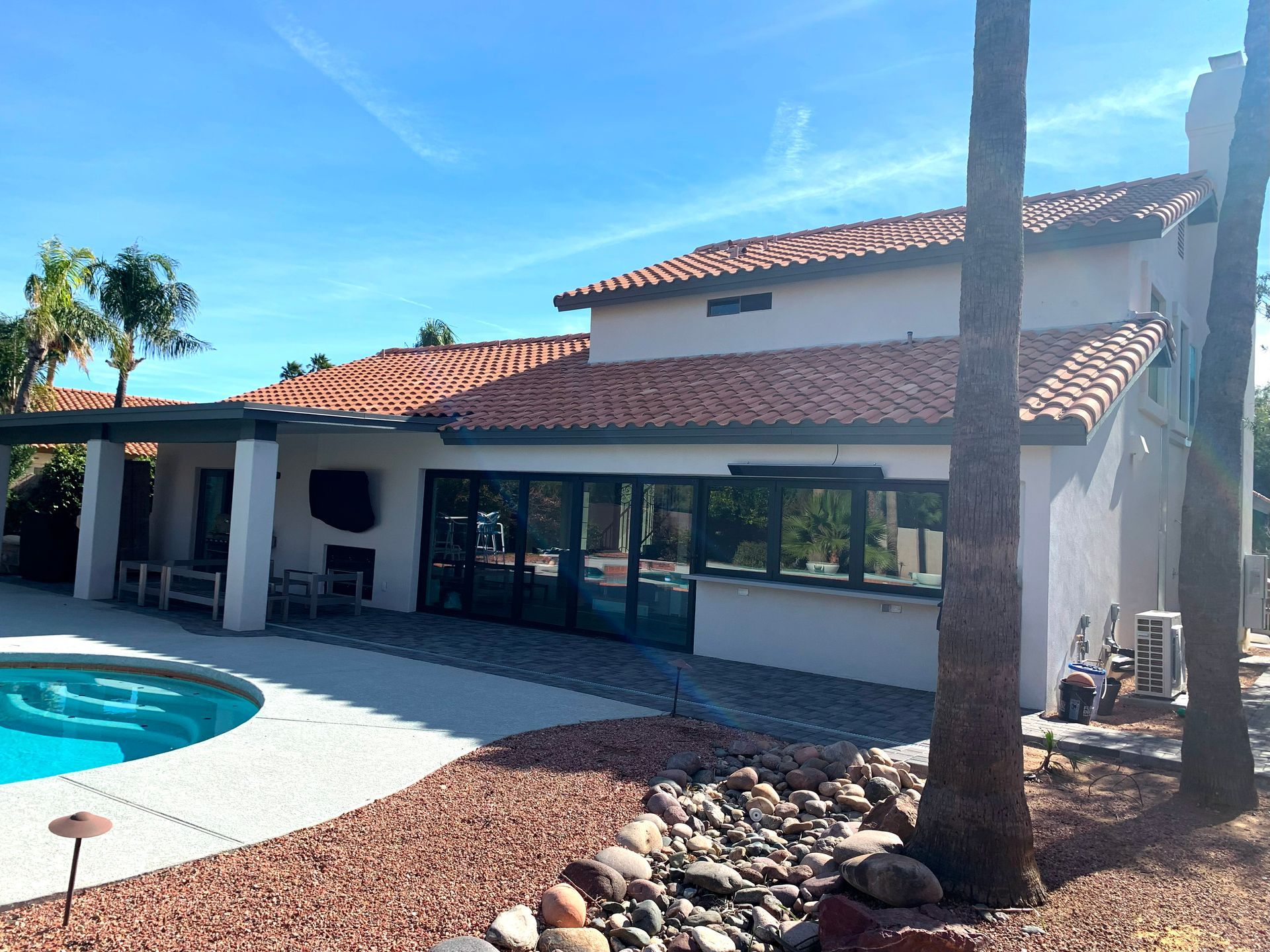 A large house with a swimming pool in front of it