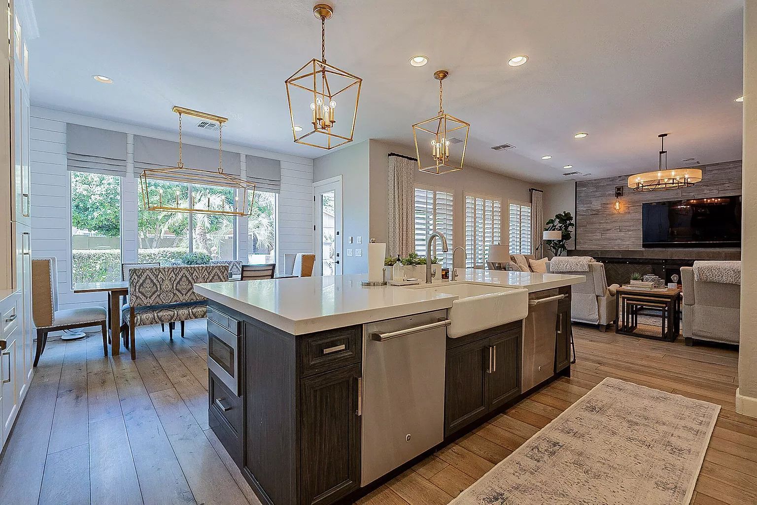 A kitchen with a large island and stainless steel appliances.