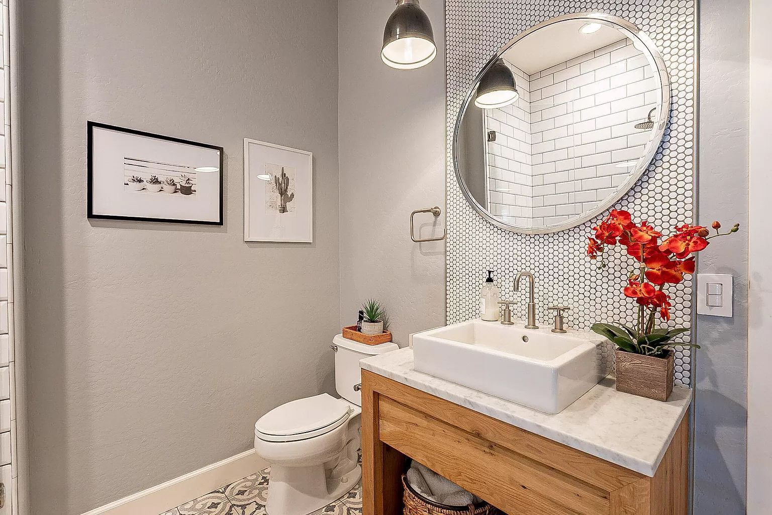 A bathroom with a sink , toilet and mirror.