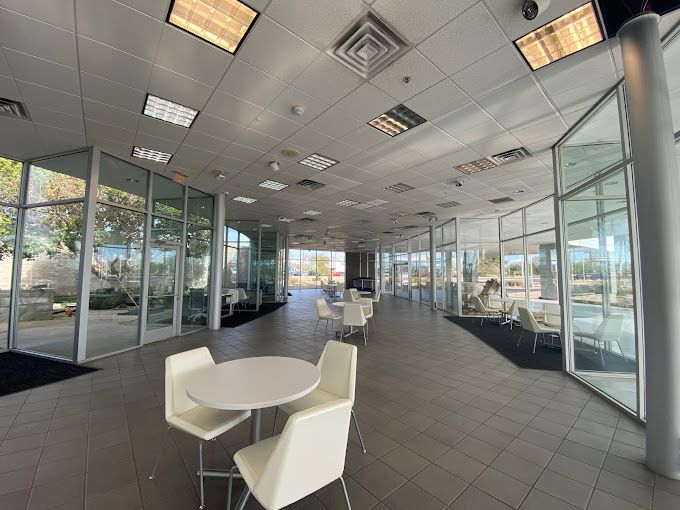 A large room with tables and chairs in it.