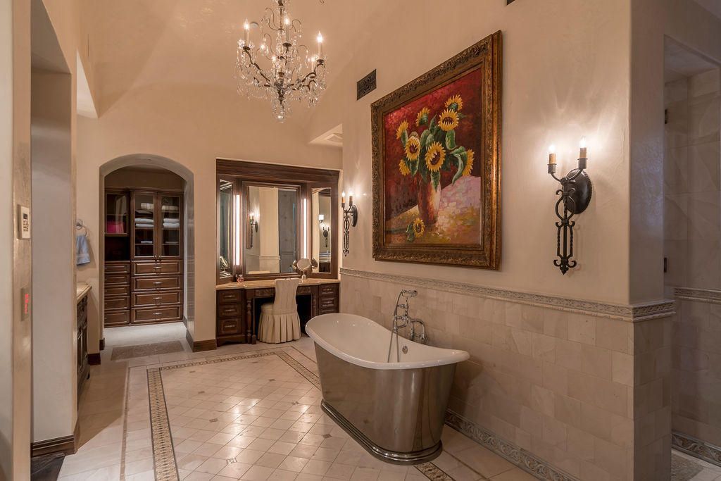 A bathroom with a bathtub and a painting on the wall.