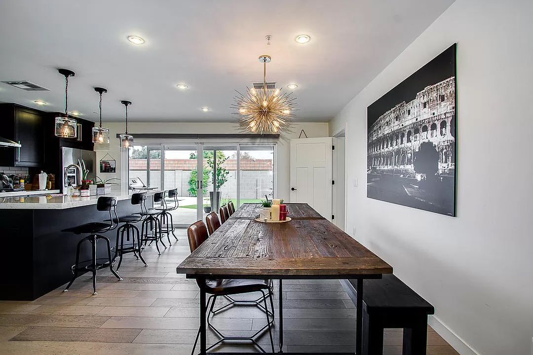 There is a long wooden table in the middle of the room.