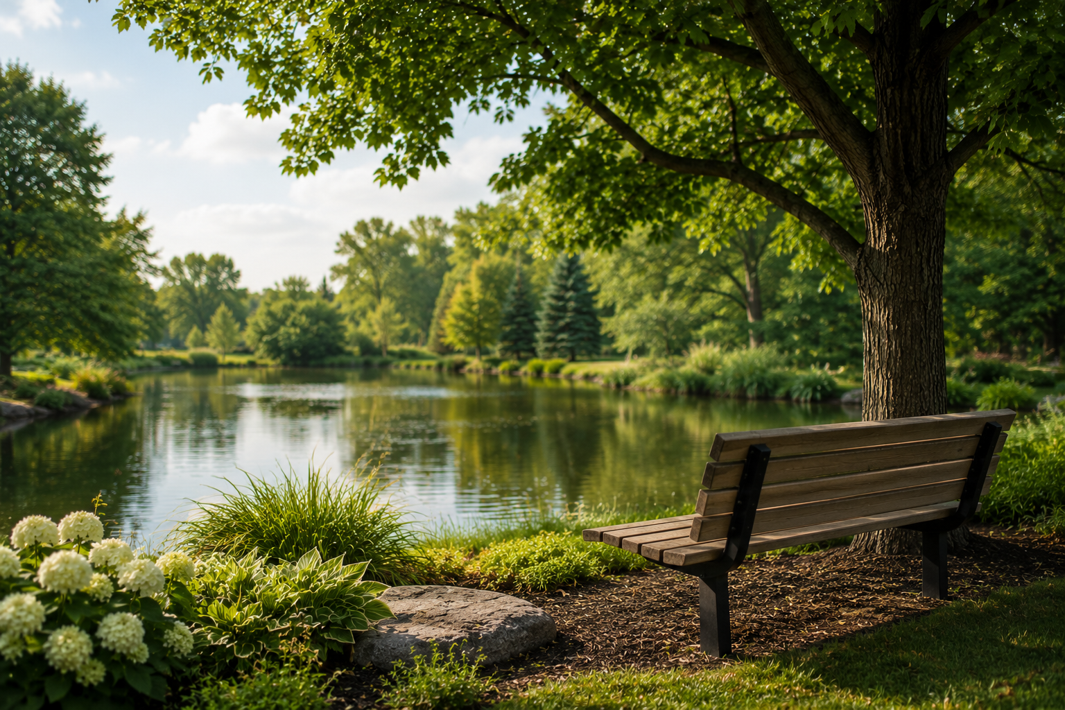 Funeral home memorial garden with bench overlooking a peaceful pond in Morrison, IL.