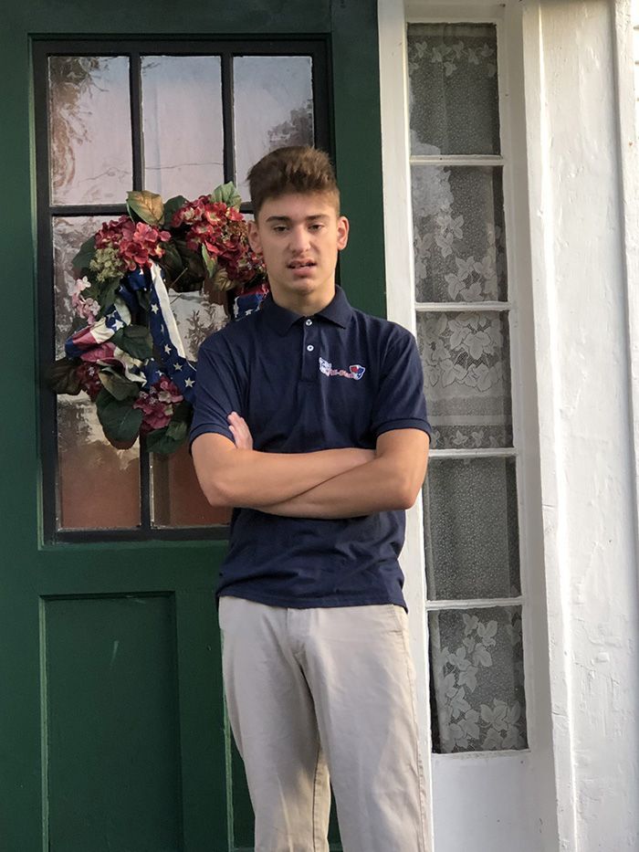 kid standing in front of a door
