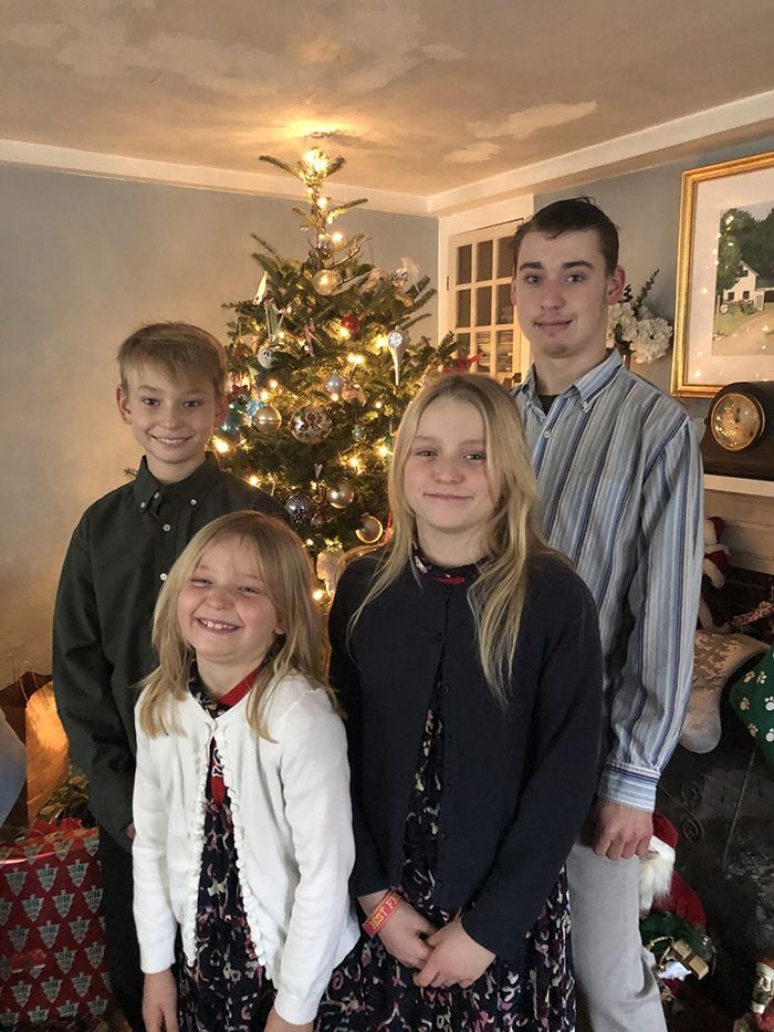 kids in front of Christmas tree