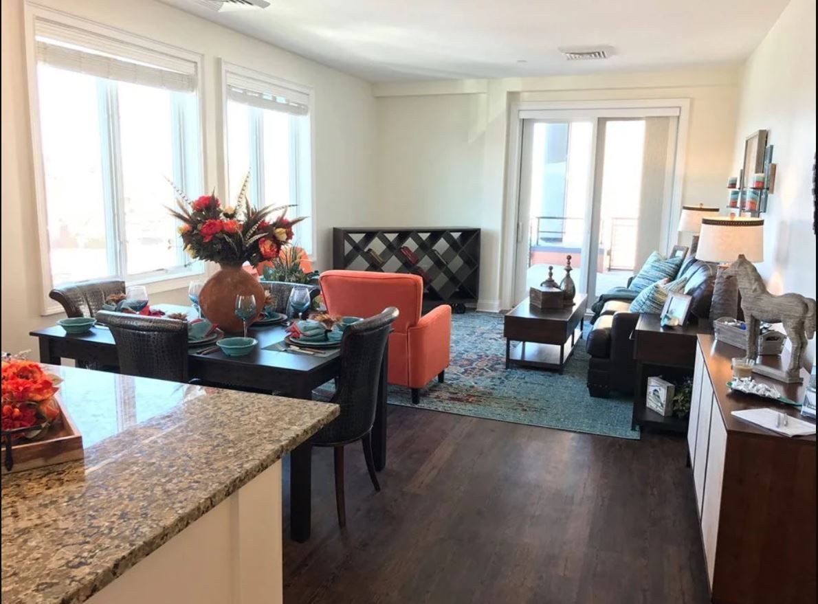 A living room with a table and chairs and a couch