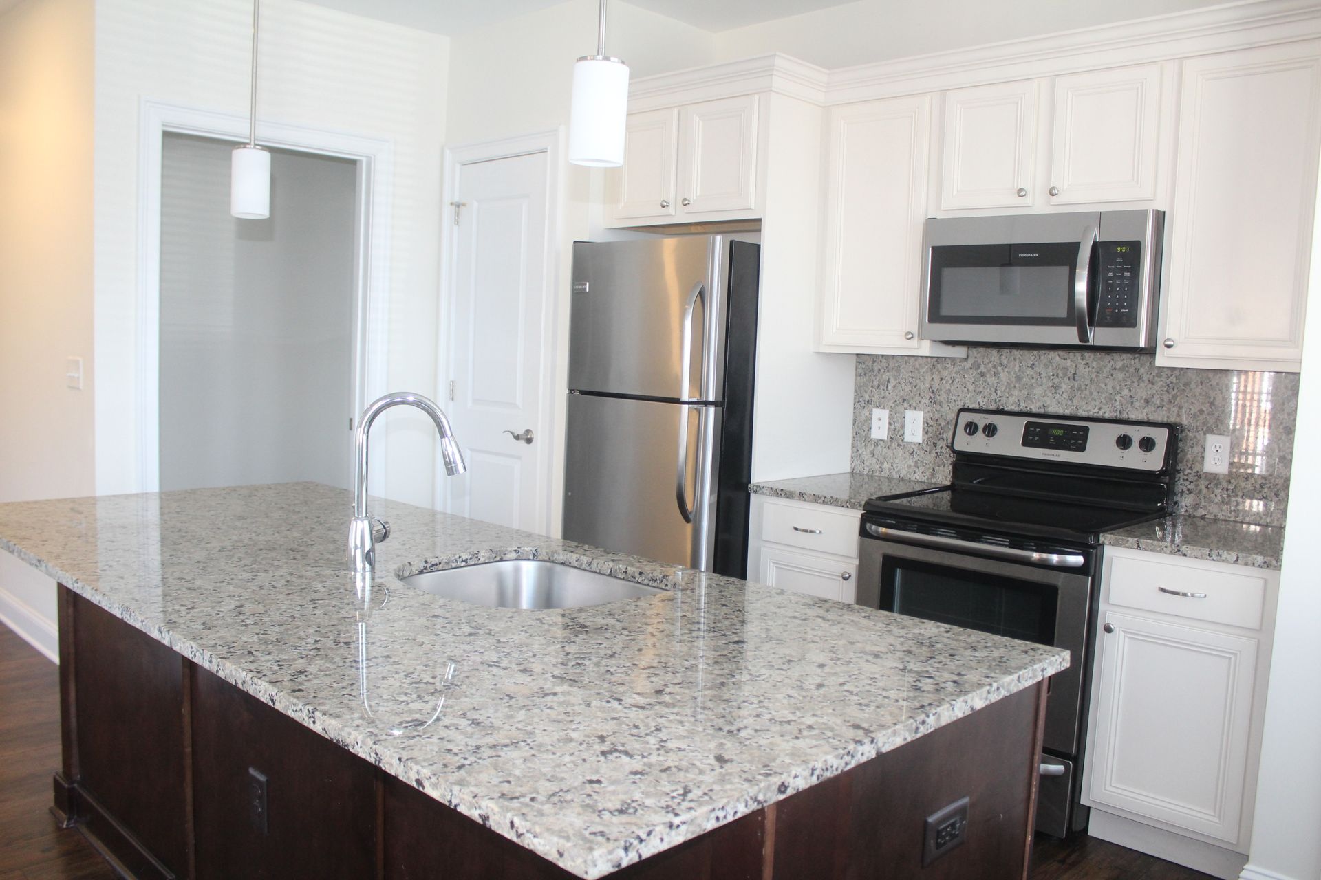 A kitchen with granite counter tops and stainless steel appliances