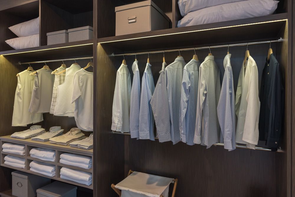 A Walk in Closet Filled with Clothes and Pillows — Rodney Lees Cabinetmaking In Casino, NSW