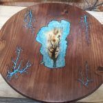 Wooden serving tray with teal resin inlay around a tree-like form. Additional teal branch details are carved on the wood.
