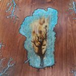 Wooden table art: Central scorched tree with turquoise outline, lightning bolt designs.