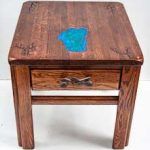 Wooden end table with a drawer and blue resin inlay.