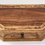 Wooden desk organizer with drawer and carved details.