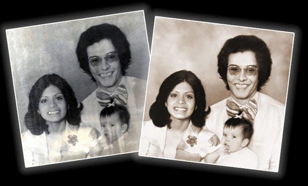 A black and white photo of a family and a baby