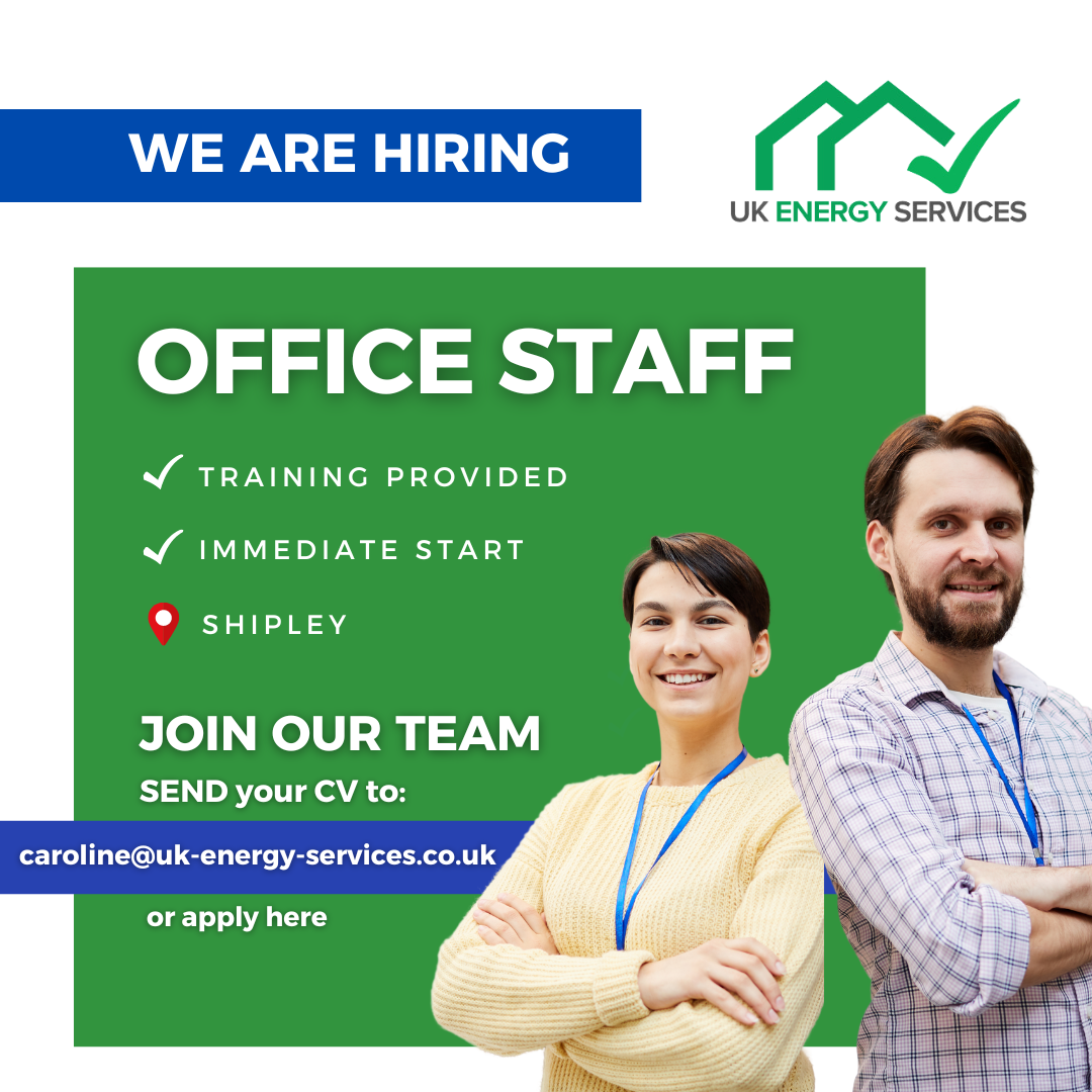 A man and a woman are standing next to each other in front of a sign that says we are hiring office staff