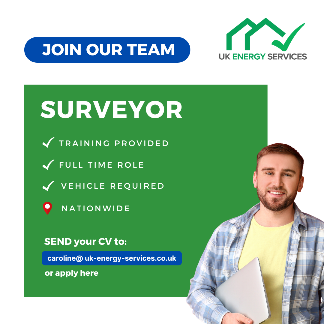 A man is holding a laptop in front of a green sign that says surveyor