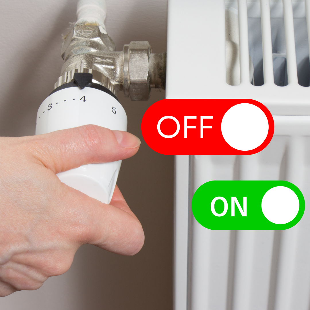 A person is adjusting a thermostat with a red button that says off and a green button that says on
