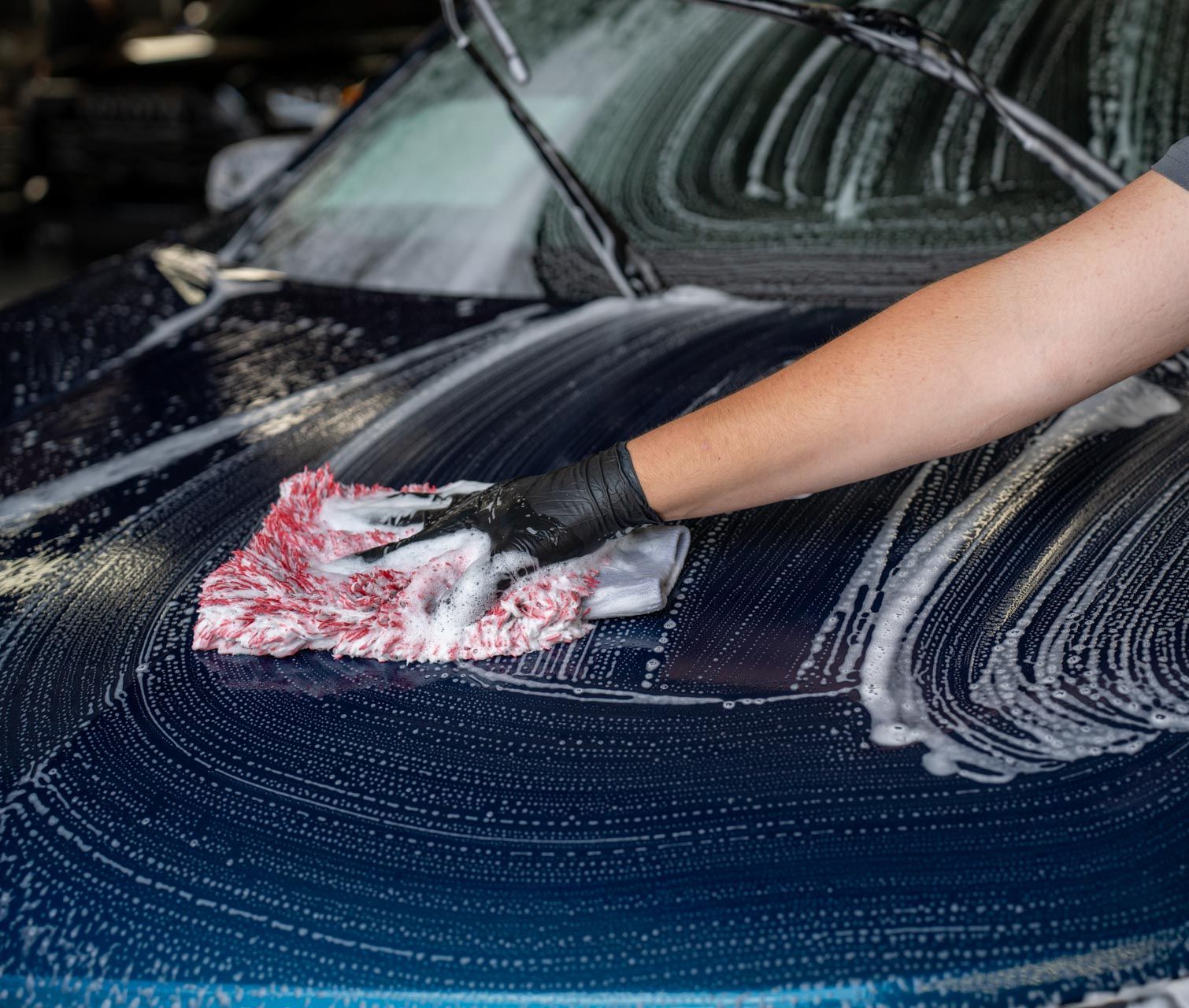 A blue subaru wrx sti is parked in a garage.