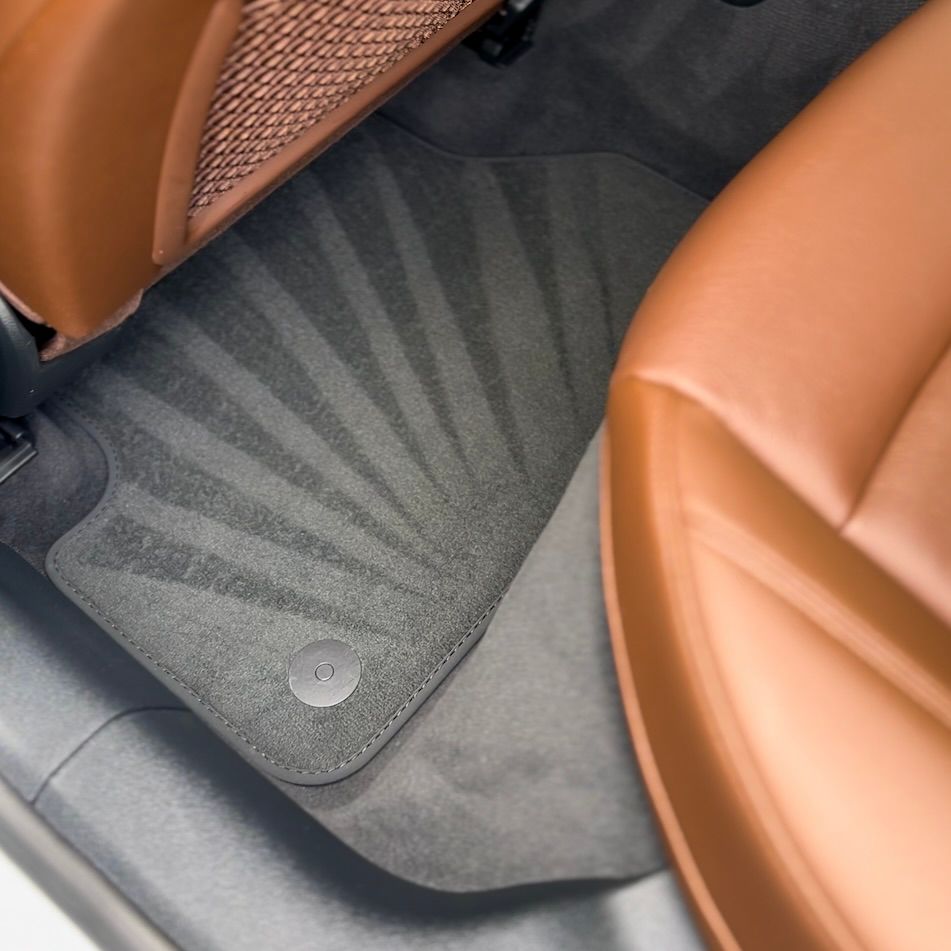 A car with brown seats and a black floor mat