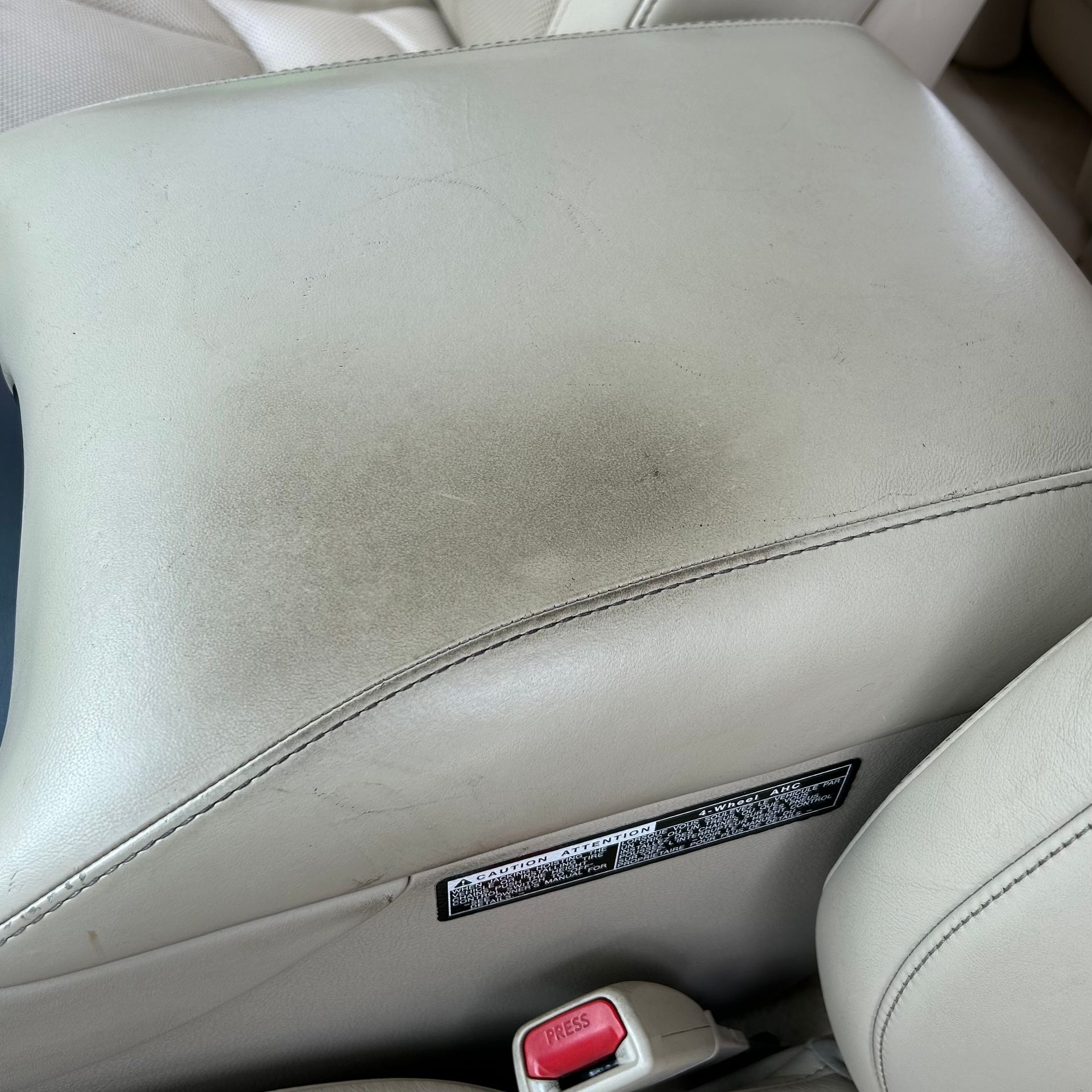 A close up of a car arm rest with a red button on it