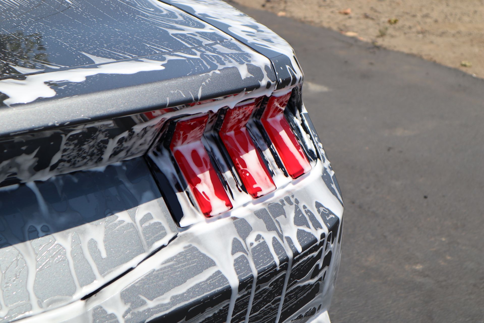 A car is being washed with soap and water.