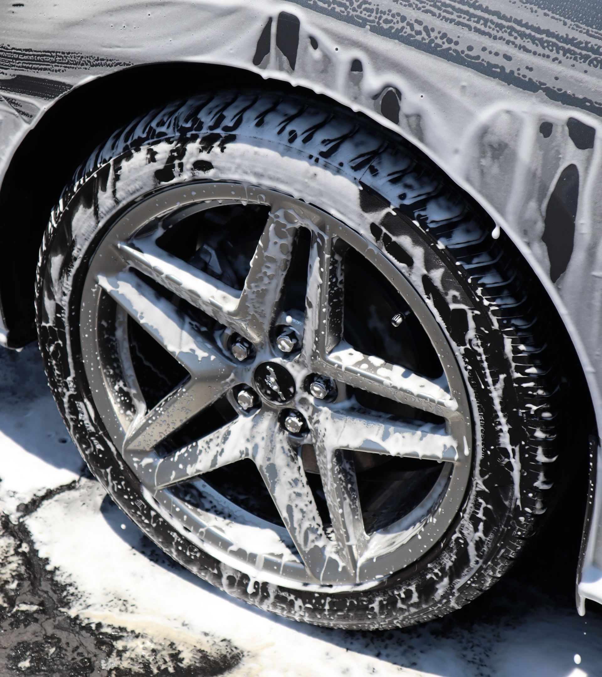 A close up of a car wheel with foam on it