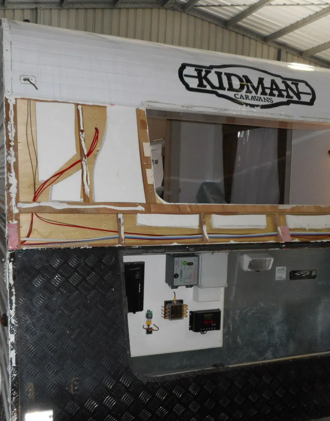 A Kidman Camper Is Being Repaired In A Warehouse — Affordable Caravan Repairs in Bundaberg, QLD