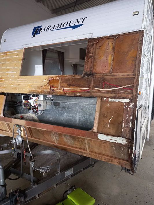 A Trailer Is Being Repaired In A Garage — Affordable Caravan Repairs in Bundaberg, QLD