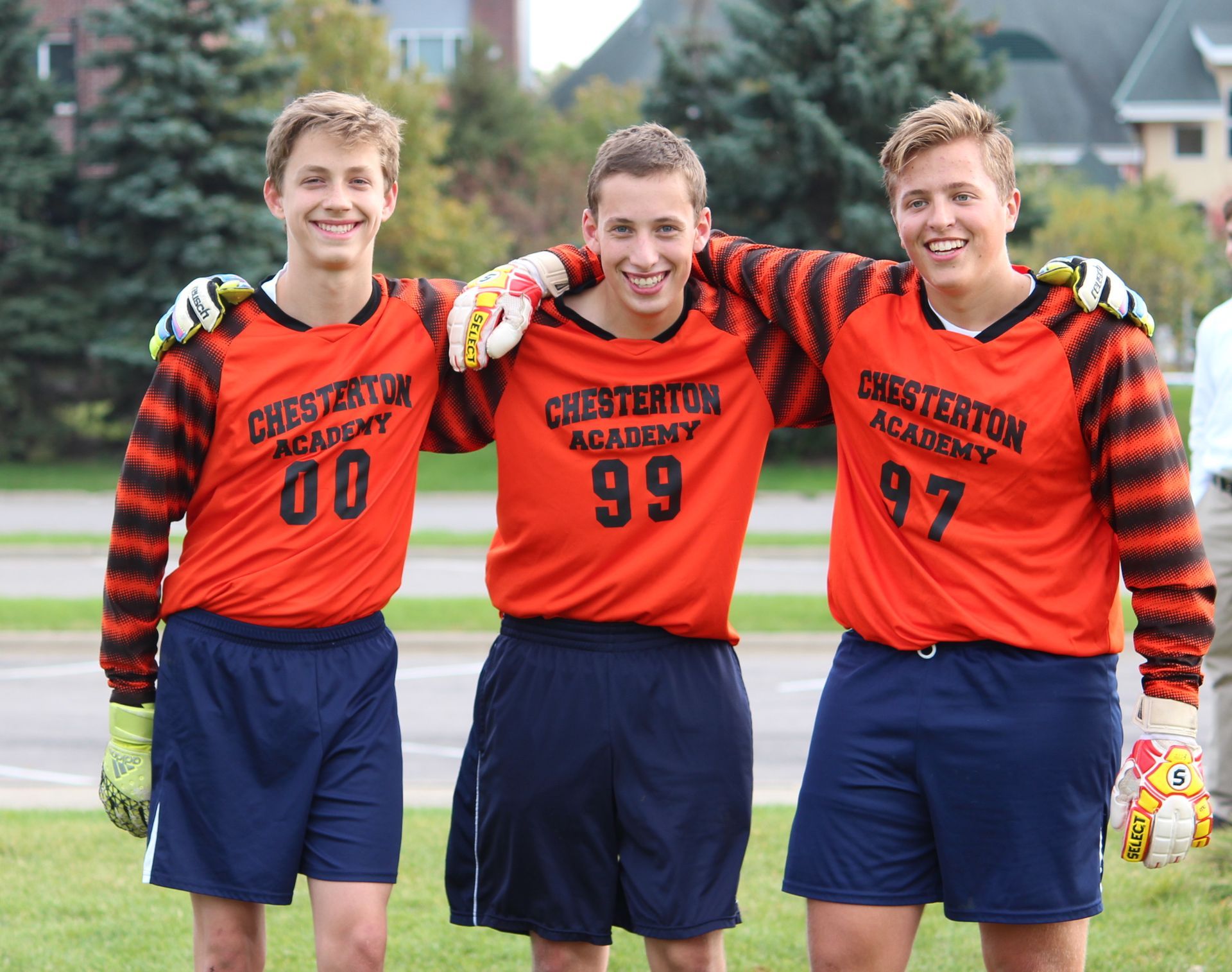 Three soccer players from chesterton academy are posing for a picture
