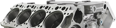 Engine block close-up, with multiple cylinder holes, showing cast metal construction. | Auto Source Of West Michigan