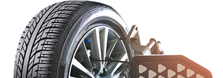 Car tire on a wheel, detail of a balancing machine. | Auto Source Of West Michigan