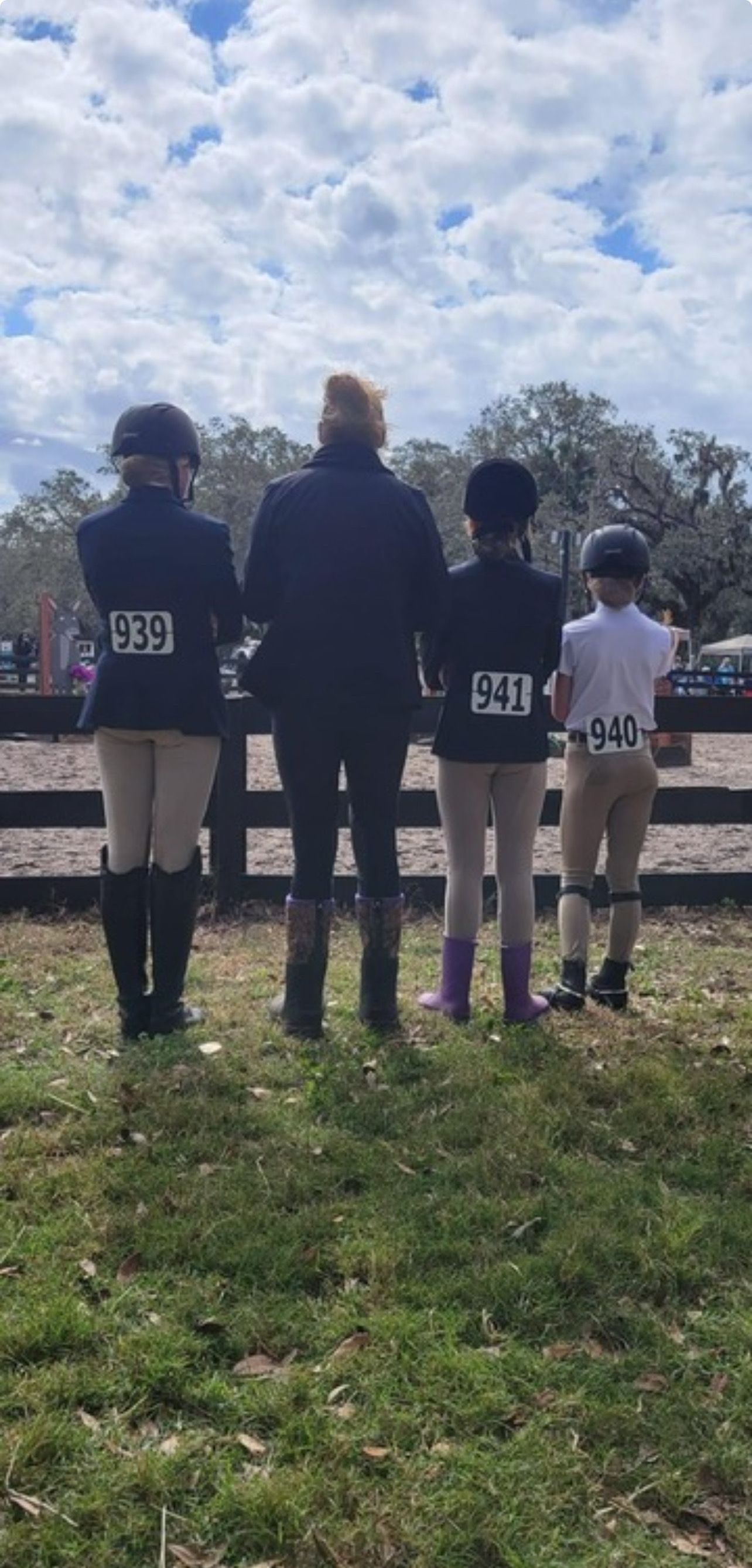 A group of people standing next to each other in a field.