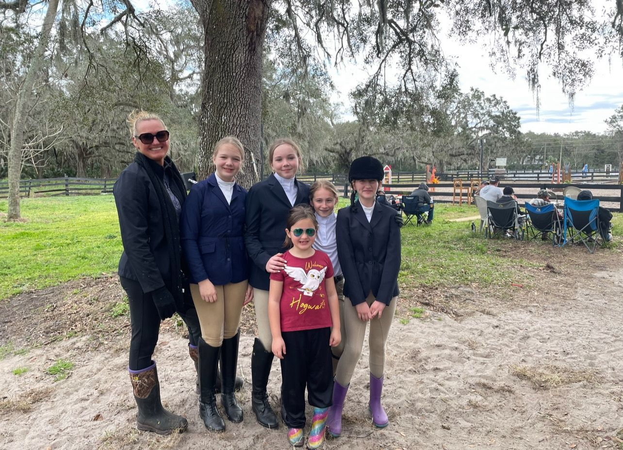 A group of people standing next to each other in a field.