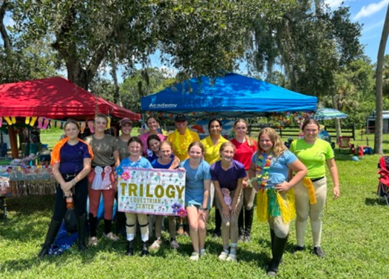 A group of young girls are posing for a picture in a park.