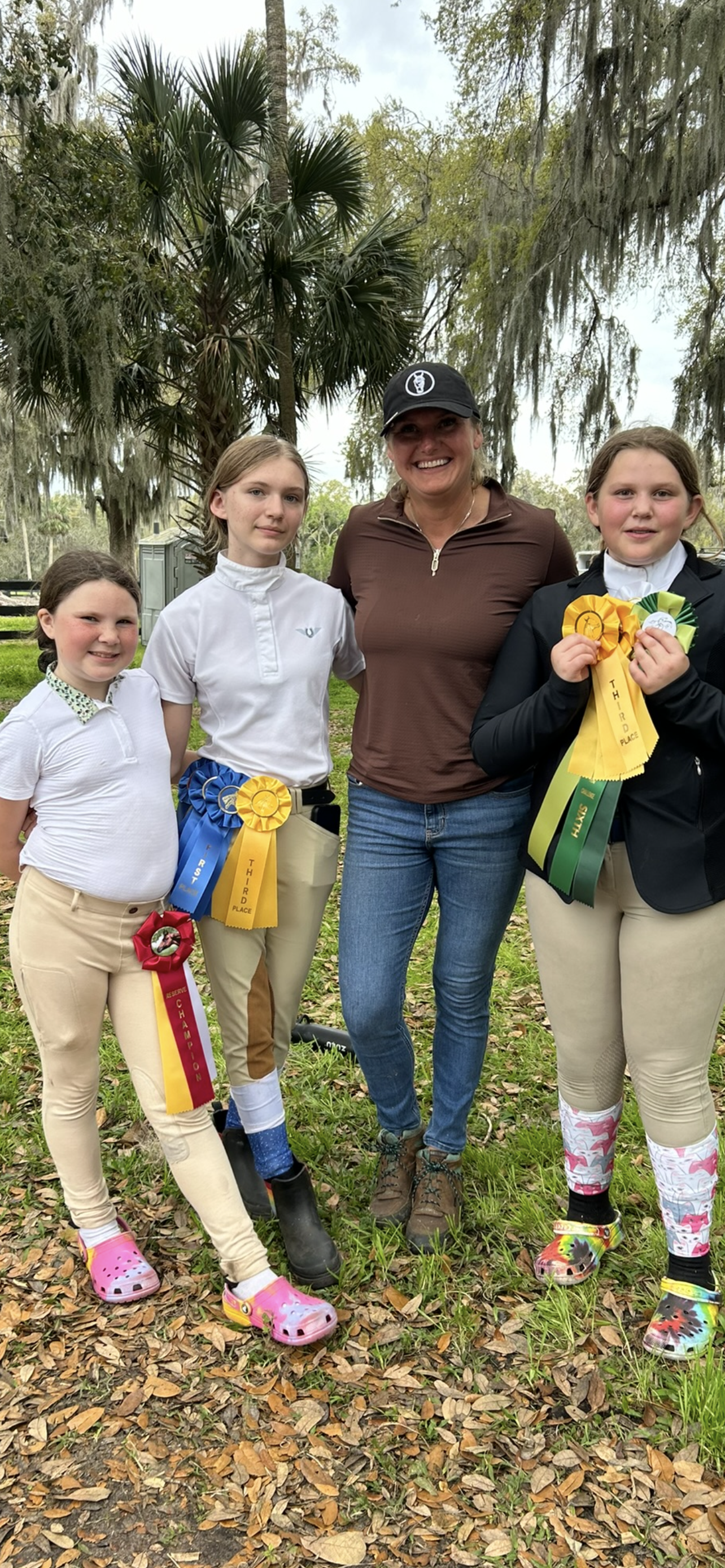 A group of people standing next to each other holding ribbons.