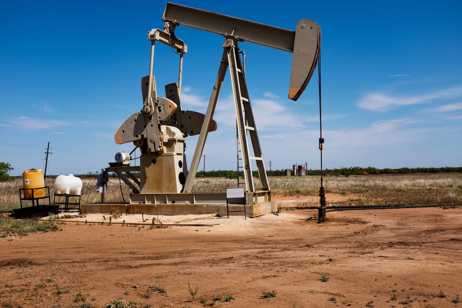 An oil pump in the middle of a dirt field