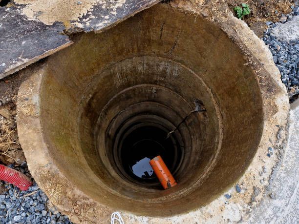 A hole in the ground with a pipe in it.