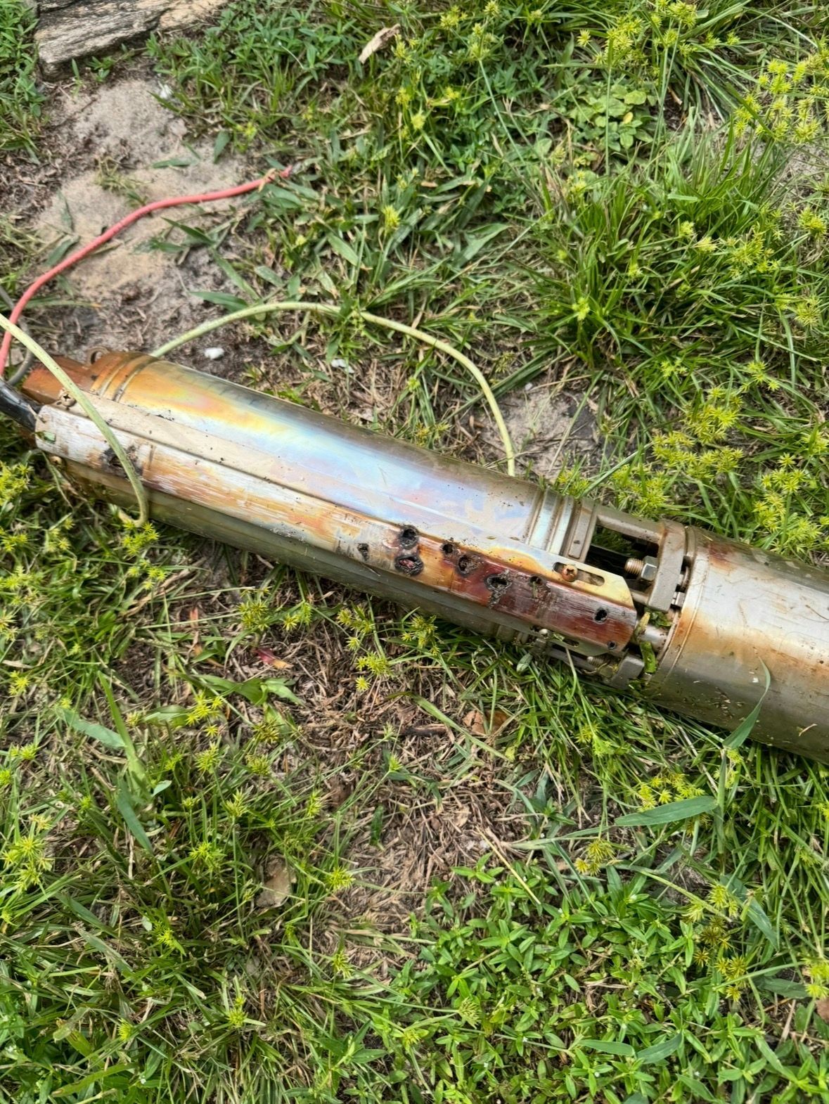 Running water from a faucet with a hand reaching toward the handle.