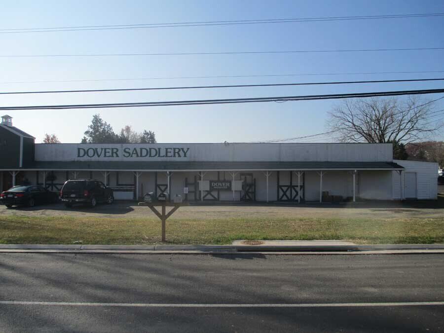 A white building with a sign that says dover saddlery