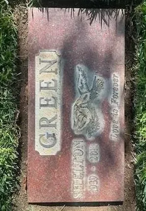 Headstone for Shelton Green (1930-2011), with a rabbit carving and the word 